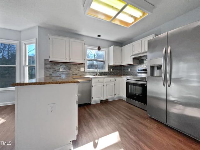 kitchen with white cabinetry, decorative light fixtures, dark wood-type flooring, and appliances with stainless steel finishes