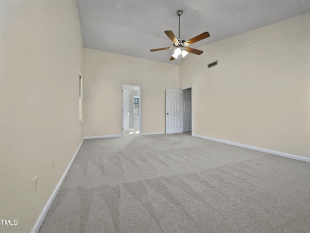 spare room with ceiling fan, light carpet, and high vaulted ceiling