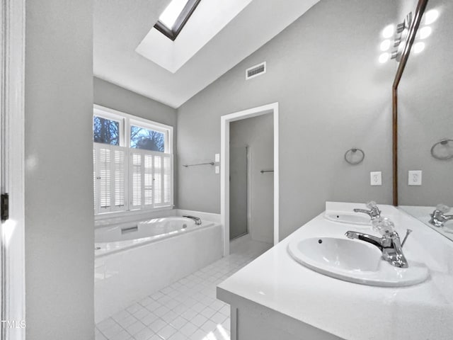 bathroom featuring tile patterned floors, vanity, lofted ceiling with skylight, and plus walk in shower