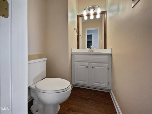 bathroom featuring hardwood / wood-style flooring, vanity, and toilet