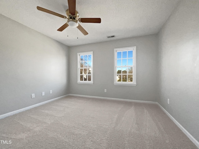 spare room with ceiling fan, carpet floors, and a textured ceiling