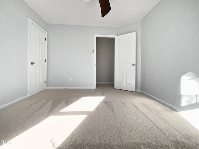 unfurnished bedroom featuring ceiling fan and carpet flooring