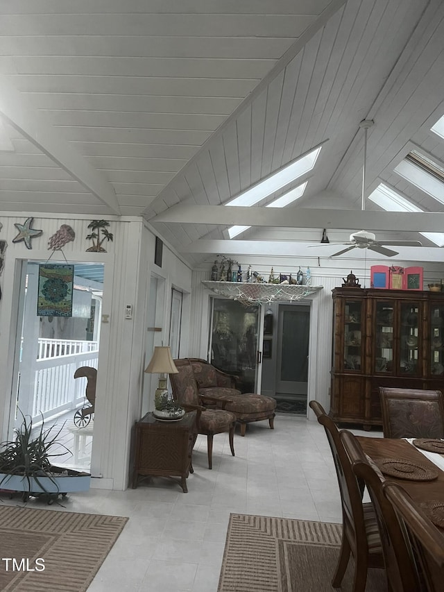 sunroom / solarium with vaulted ceiling with skylight and ceiling fan