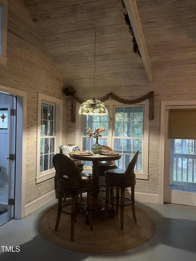 dining space featuring wooden ceiling and vaulted ceiling with beams