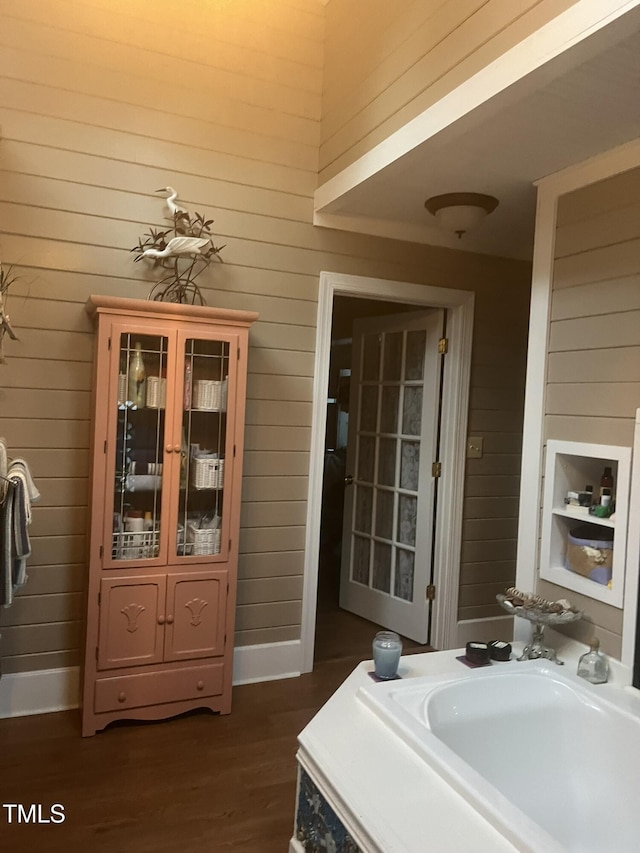 bathroom featuring wood-type flooring and wood walls