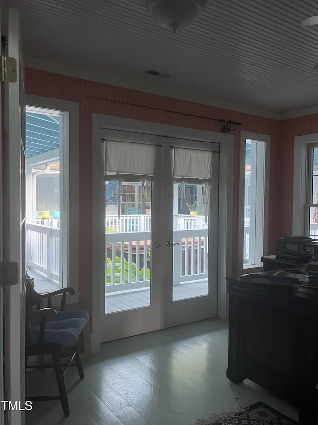 entryway with french doors and wood walls