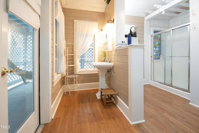 bathroom featuring hardwood / wood-style flooring and wood walls