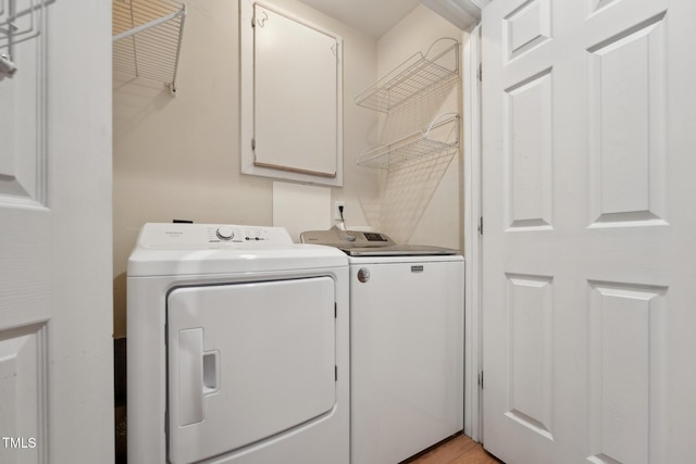 laundry room featuring cabinets and washing machine and clothes dryer