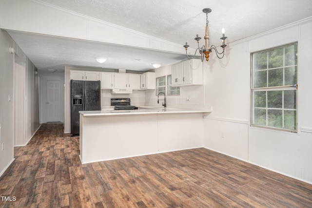 kitchen featuring white cabinetry, decorative light fixtures, black appliances, and kitchen peninsula