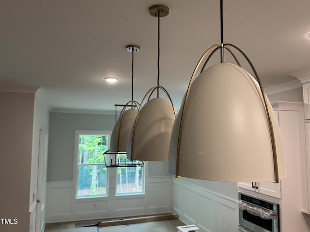 118 Sanderway Dr, Chapel Hill, NC 27516 - detailed view of crown molding, a wainscoted wall, a decorative wall, white cabinetry, and oven