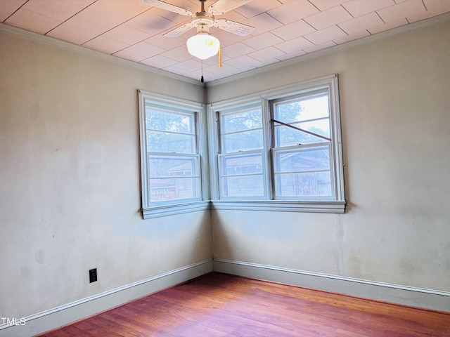 unfurnished room featuring ceiling fan, ornamental molding, and light hardwood / wood-style flooring