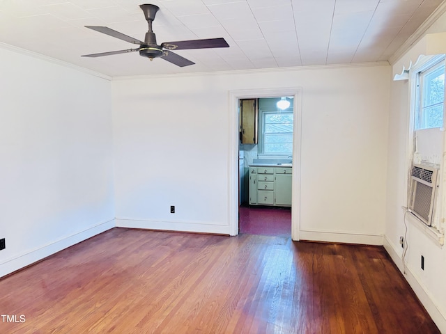 empty room featuring dark hardwood / wood-style flooring, crown molding, and ceiling fan