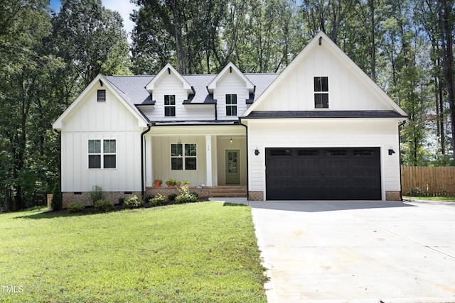 modern farmhouse style home with a garage, covered porch, and a front lawn