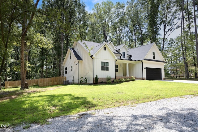 modern inspired farmhouse featuring a garage, central AC, a front yard, and covered porch