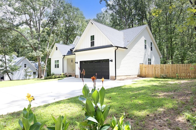 modern farmhouse with a garage and a front lawn