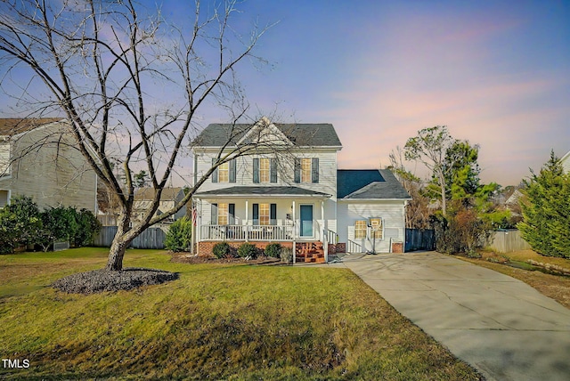 view of front of home featuring a porch and a yard