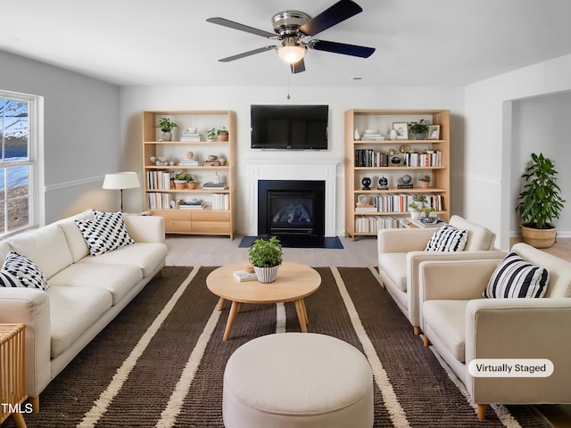 living room with ceiling fan and carpet floors