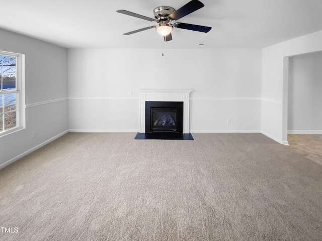 unfurnished living room featuring light carpet and ceiling fan