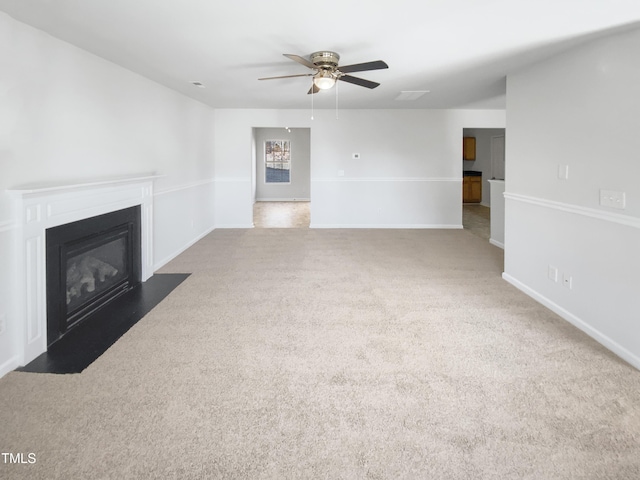 unfurnished living room featuring ceiling fan and carpet flooring