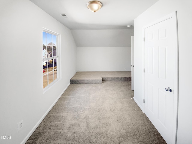 bonus room featuring vaulted ceiling and carpet