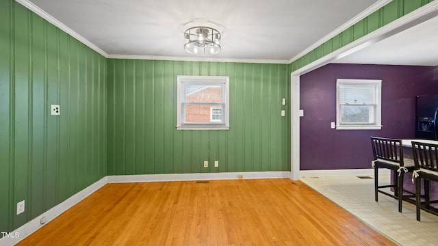 entrance foyer with crown molding, hardwood / wood-style flooring, and a chandelier