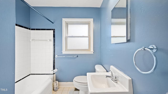 full bathroom with sink, toilet, tiled shower / bath combo, and tile patterned flooring