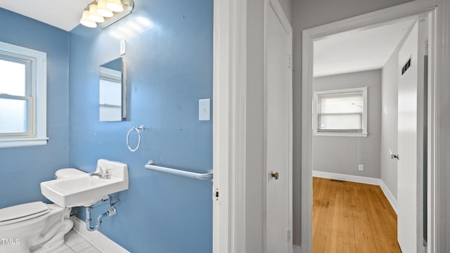 bathroom featuring sink, hardwood / wood-style floors, and toilet