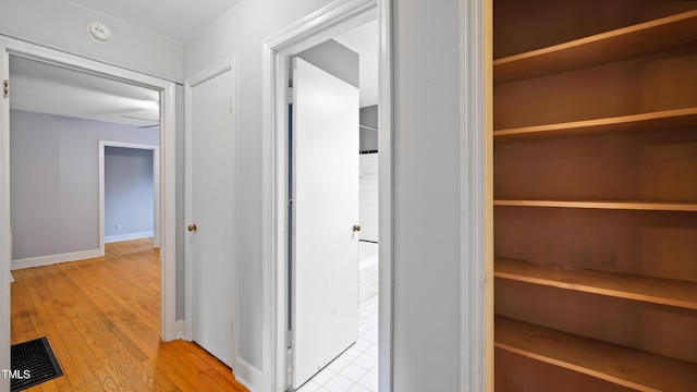 corridor with light wood-type flooring