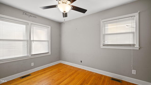 empty room featuring hardwood / wood-style floors and ceiling fan