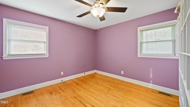 unfurnished room with hardwood / wood-style floors and ceiling fan