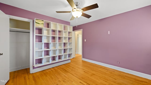 unfurnished bedroom featuring hardwood / wood-style flooring, ceiling fan, and a closet