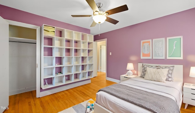 bedroom featuring ceiling fan, hardwood / wood-style floors, and a closet