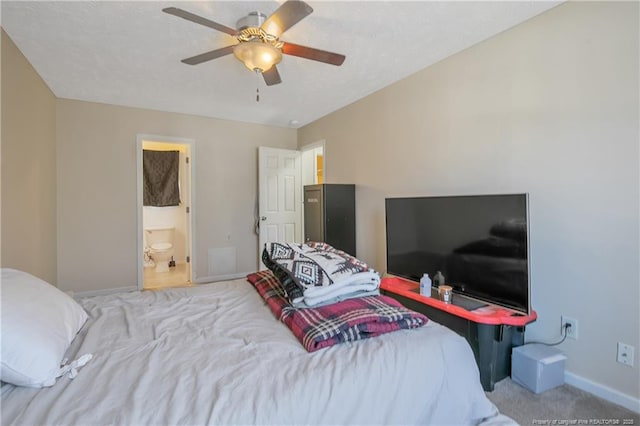 carpeted bedroom featuring a textured ceiling, ceiling fan, and ensuite bathroom