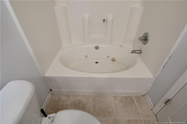 bathroom with a washtub and toilet