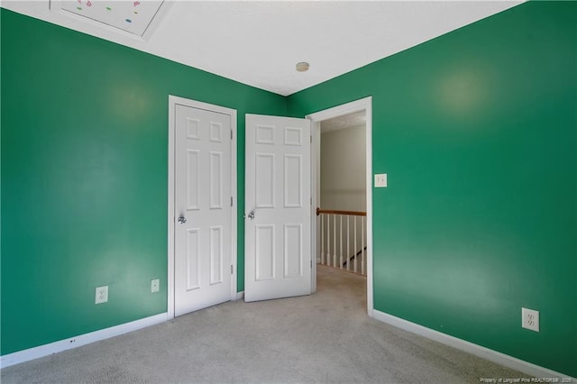 unfurnished bedroom featuring a closet and light carpet