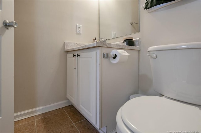 bathroom with tile patterned flooring, vanity, and toilet