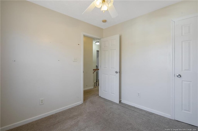 unfurnished bedroom featuring light carpet and ceiling fan