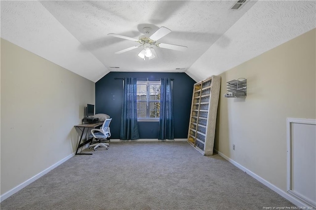 unfurnished office with lofted ceiling, ceiling fan, carpet floors, and a textured ceiling