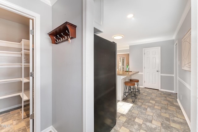 hallway featuring crown molding