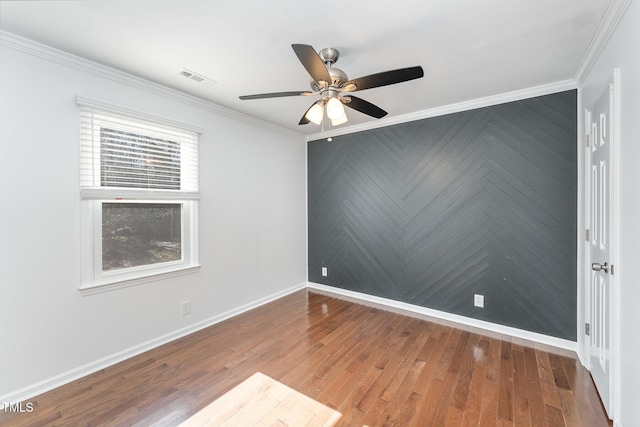 empty room with crown molding, ceiling fan, and wood-type flooring