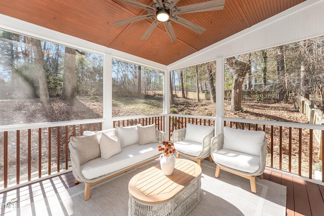 sunroom / solarium with wood ceiling, ceiling fan, and vaulted ceiling