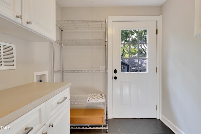 entryway featuring dark tile patterned floors