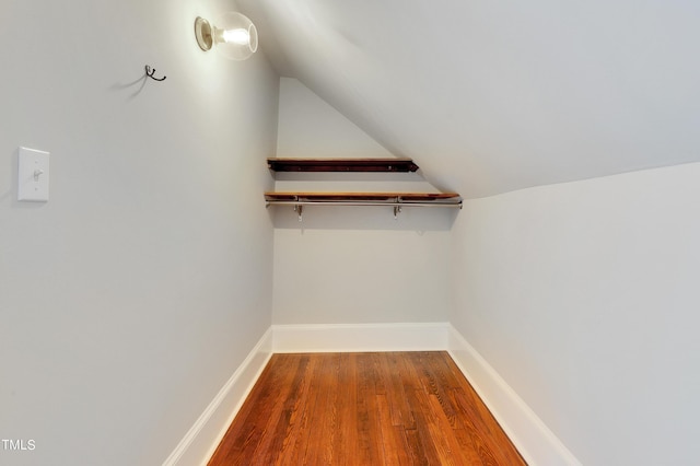 spacious closet featuring vaulted ceiling and hardwood / wood-style floors