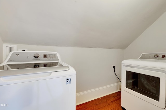 laundry area featuring washing machine and dryer and dark hardwood / wood-style floors