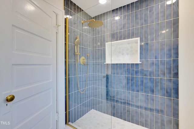 bathroom with tiled shower