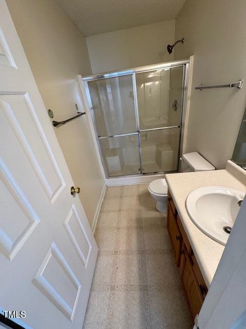 bathroom with vanity, toilet, and walk in shower