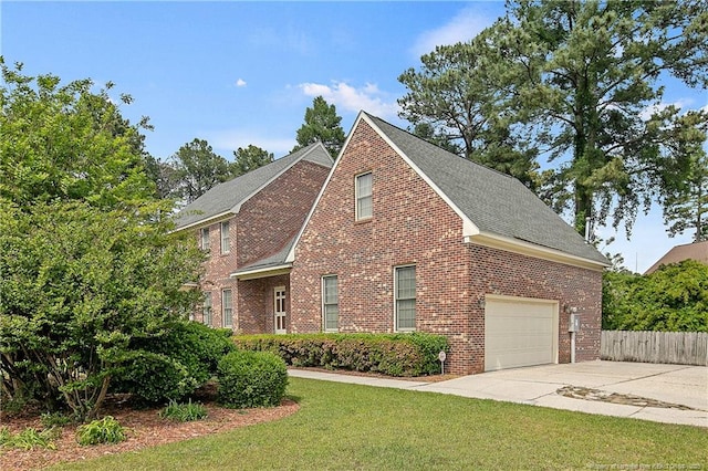 view of front of property with a garage and a front lawn