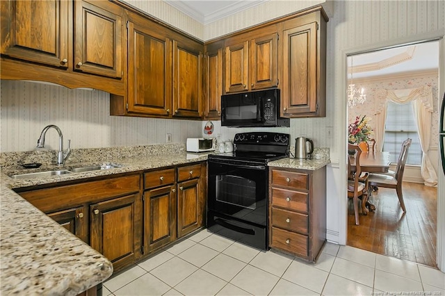 kitchen with crown molding, light stone countertops, sink, and black appliances