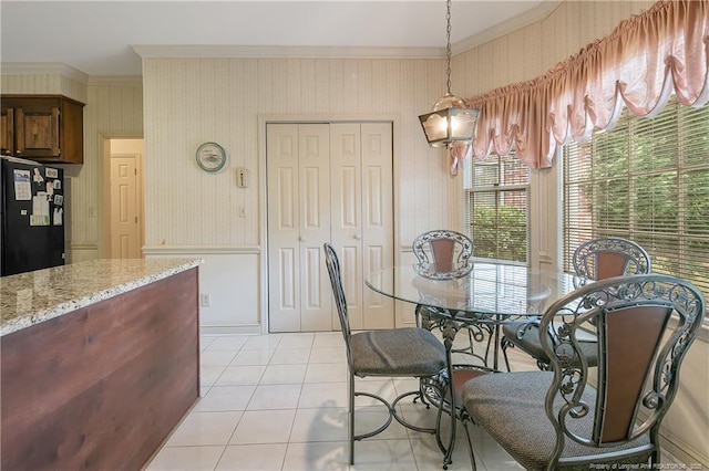 tiled dining room featuring ornamental molding