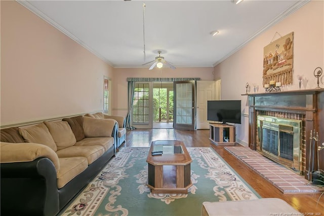 living room featuring hardwood / wood-style flooring, a fireplace, and ornamental molding